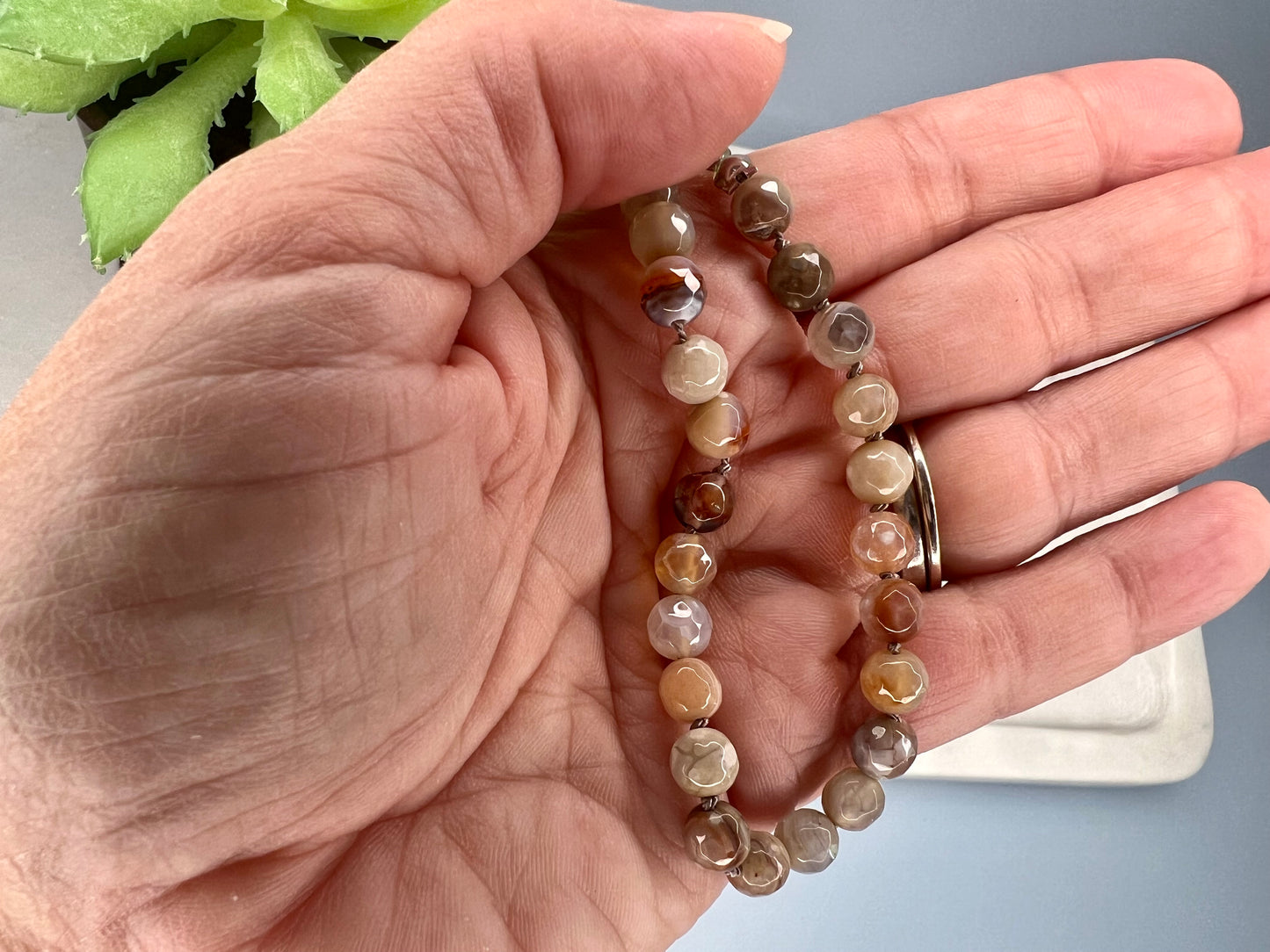 a person holding two bracelets in their hand