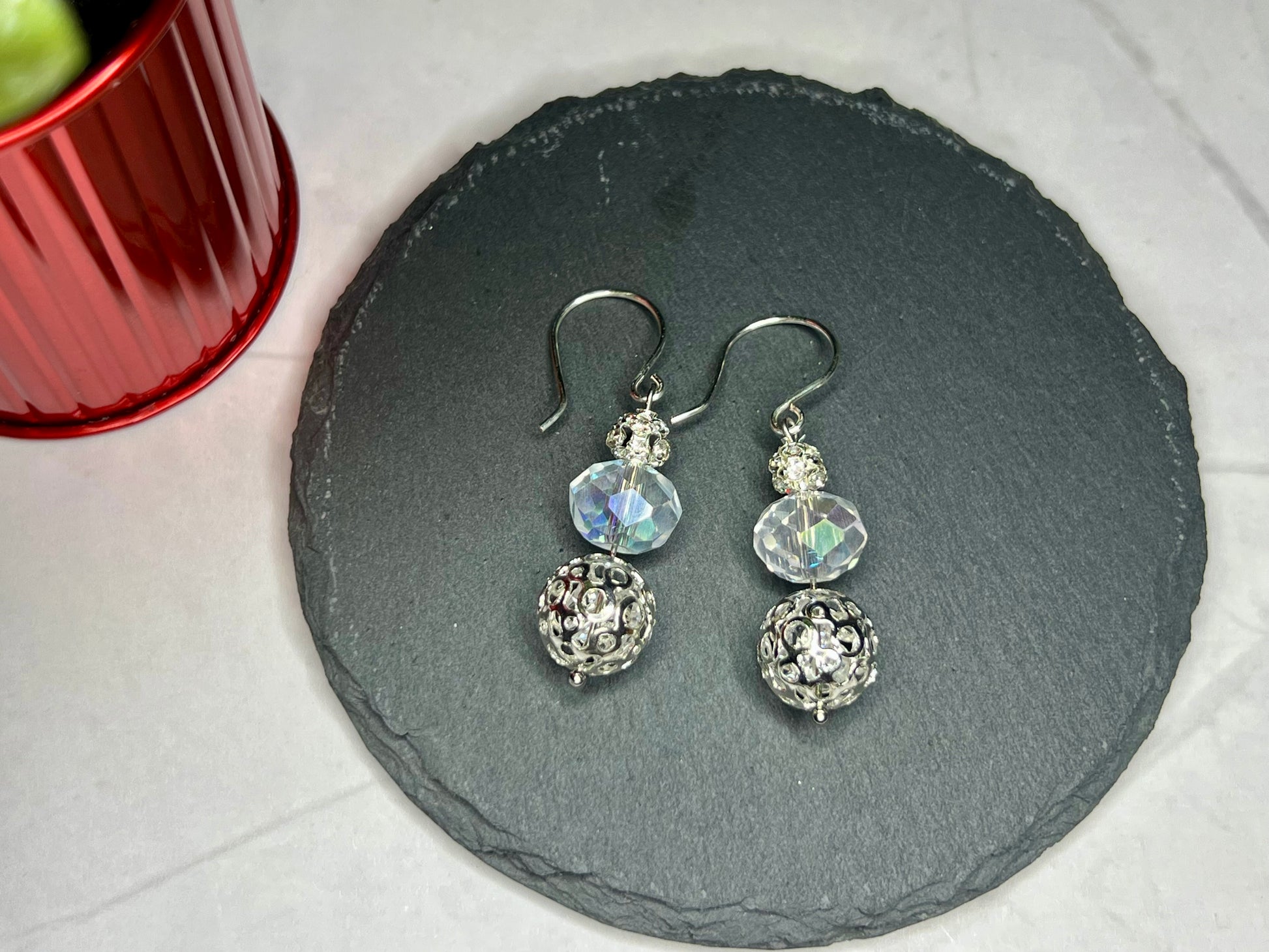 a close up of a pair of earrings on a plate