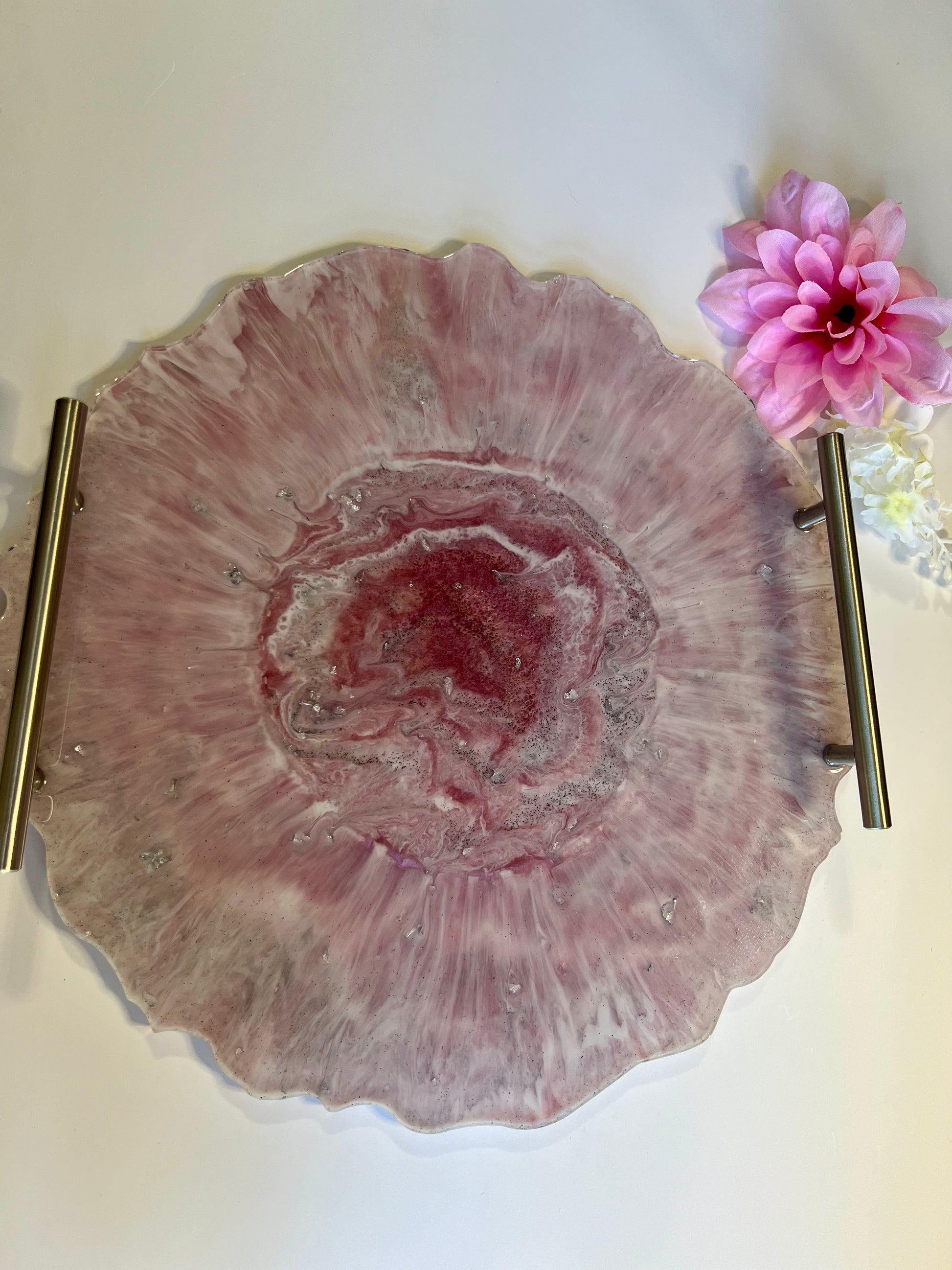 a pink flower sitting on top of a white table