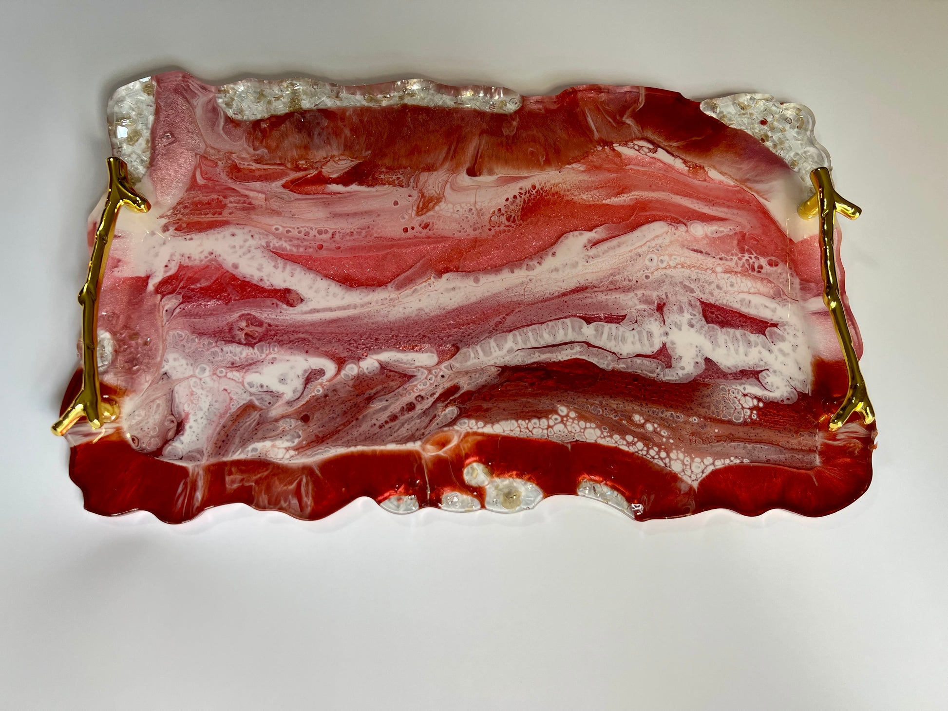 a piece of bacon sitting on top of a glass plate